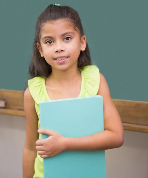 cute-pupil-smiling-camera-classroom-holding-notepad (1)