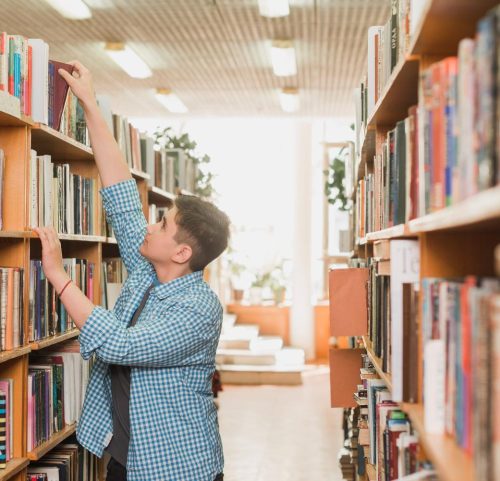 teenager-taking-book-from-bookshelf (1)